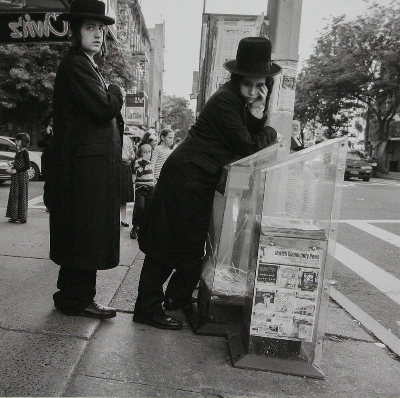 Man leaning on Newspaper Dispenser
