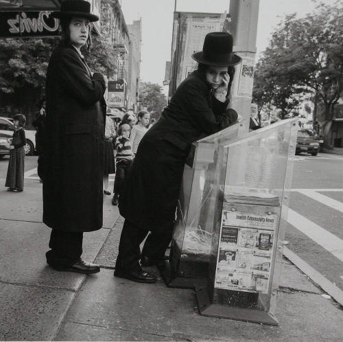 Man leaning on Newspaper Dispenser